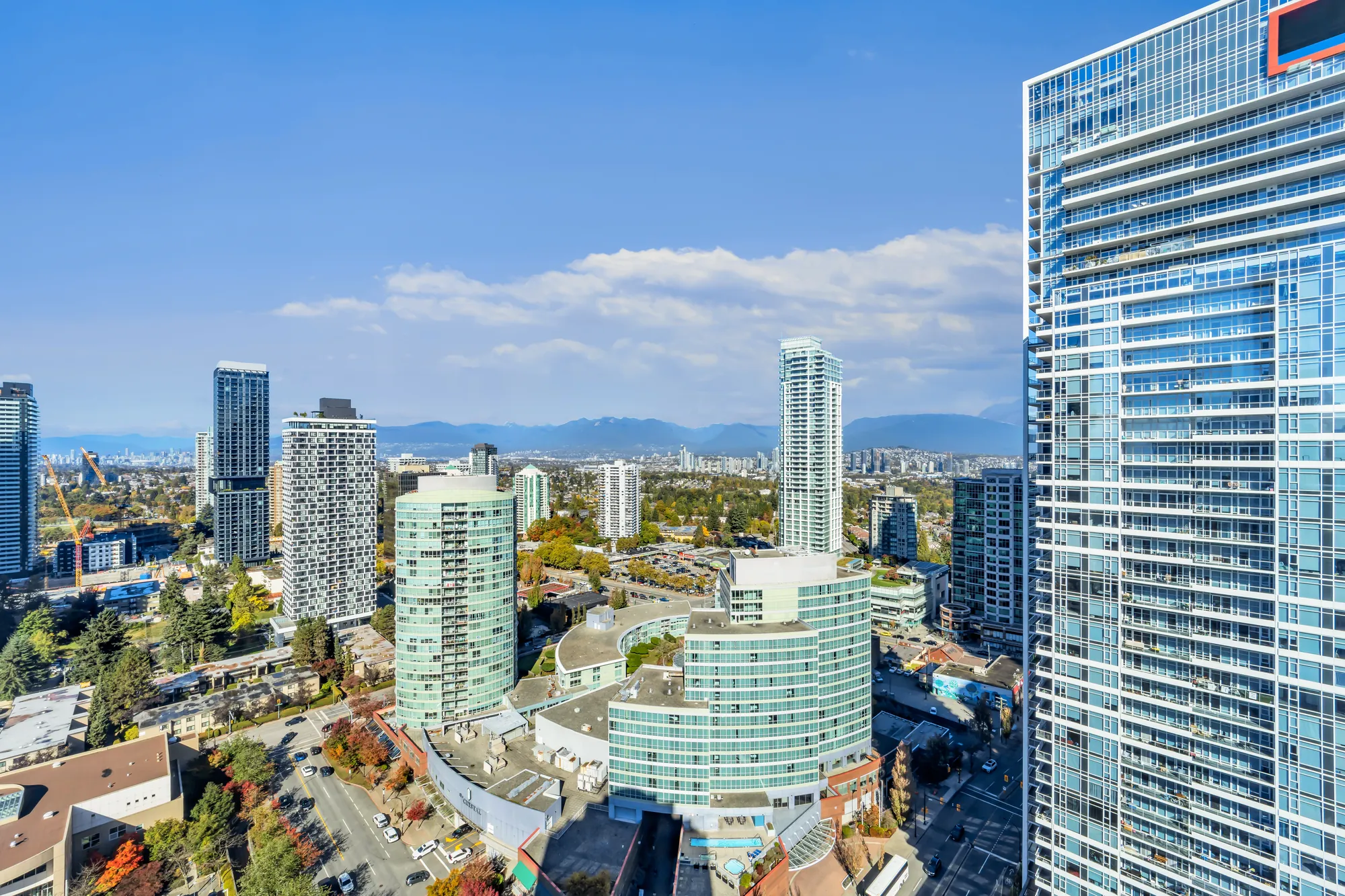The view over Metrotown toward the North Shore mountains, a glass tower at the right