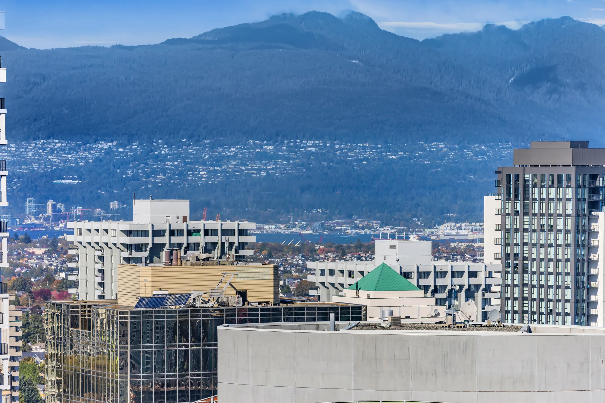 A long view to the North Shore mountains over the rooftops